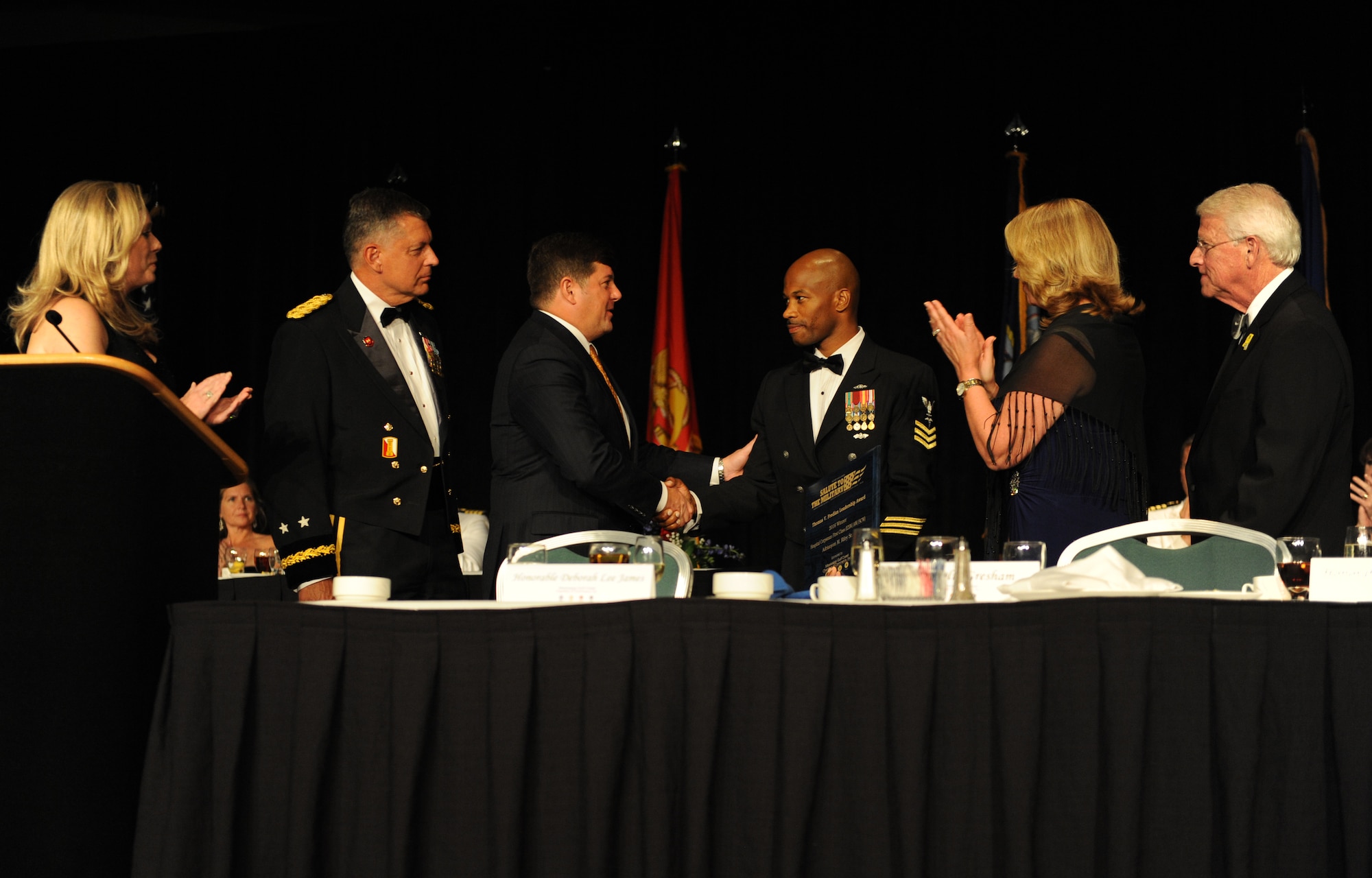 U.S. Navy Petty Officer 1st Class Adrianyon Riley, Sr., Naval Construction Battalion Center, Gulfport, Miss., hospital corpsman, receives the Thomas V. Fredian Community Leadership Award  from members of the head table during the 38th Annual Salute to the Military at the Mississippi Coast Convention Center, Oct. 25, 2016, Biloxi, Miss. The Salute to the Military event recognized the men and women who serve in the military along the Gulf Coast. (U.S. Air Force photo by Kemberly Groue/Released)