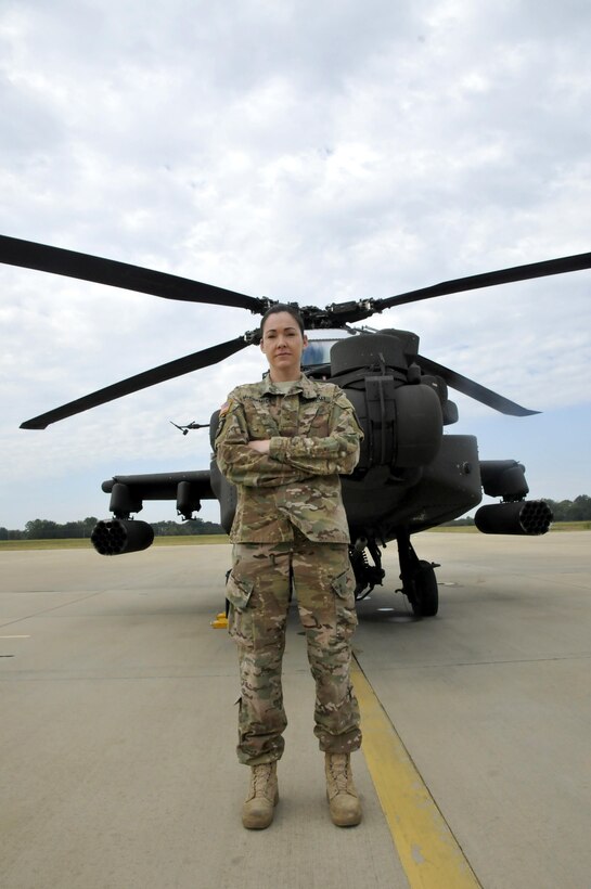 Army Warrant Officer Jessica McCormick stands in front of one of the AH-64D Apache Longbow helicopters assigned to Alpha Company, 1st Battalion, 149th Aviation Regiment, in Tupelo, Miss., Oct. 15, 2016. McCormick is the first female Apache pilot in the Mississippi Army National Guard. Army photo by Pfc. Christopher Shannon