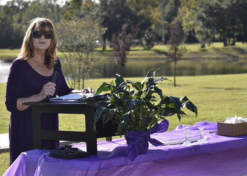 Guest speaker Lucy Forest shares her story of domestic abuse during a candlelit vigil held to raise awareness for domestic abuse victims and honor military families affected by abuse at the Hunt Community Center here, Oct. 24, 2016. Forest is a survivor of domestic abuse, but her daughter was killed as a result of an abusive relationship.