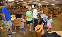 A Tyndall family takes part in the Tyndall Library open house scavenger hunt, Oct. 26, 2016. The library just went through some changes that include newer and faster computers, more available open times and better educational on the services they offer. (U.S. Air Force photo by Airman 1st Class Cody R. Miller/Released)