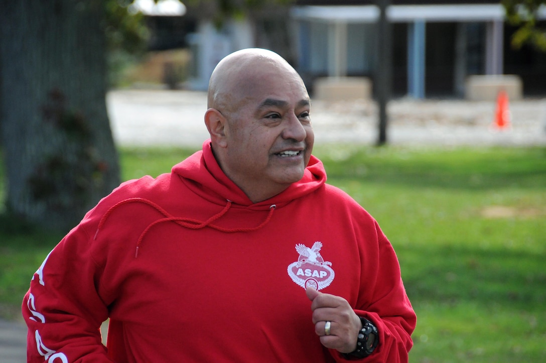 Chief Warrant Officer 3 Jorge Huitzil, assigned to the U.S. Army Reserve's 99th Regional Support Command at Joint Base McGuire-Dix-Lakehurst, New Jersey, breaks a smile just before crossing the finish line during a Red Ribbon 5K Run/3K Walk Oct. 26 at Joint Base McGuire-Dix-Lakehurst.  The event was sponsored by the base's Army Substance Abuse Program office.  Red Ribbon Week pays homage to all the men and women who have made the ultimate sacrifice in support of our nation's struggle against drug trafficking and abuse.