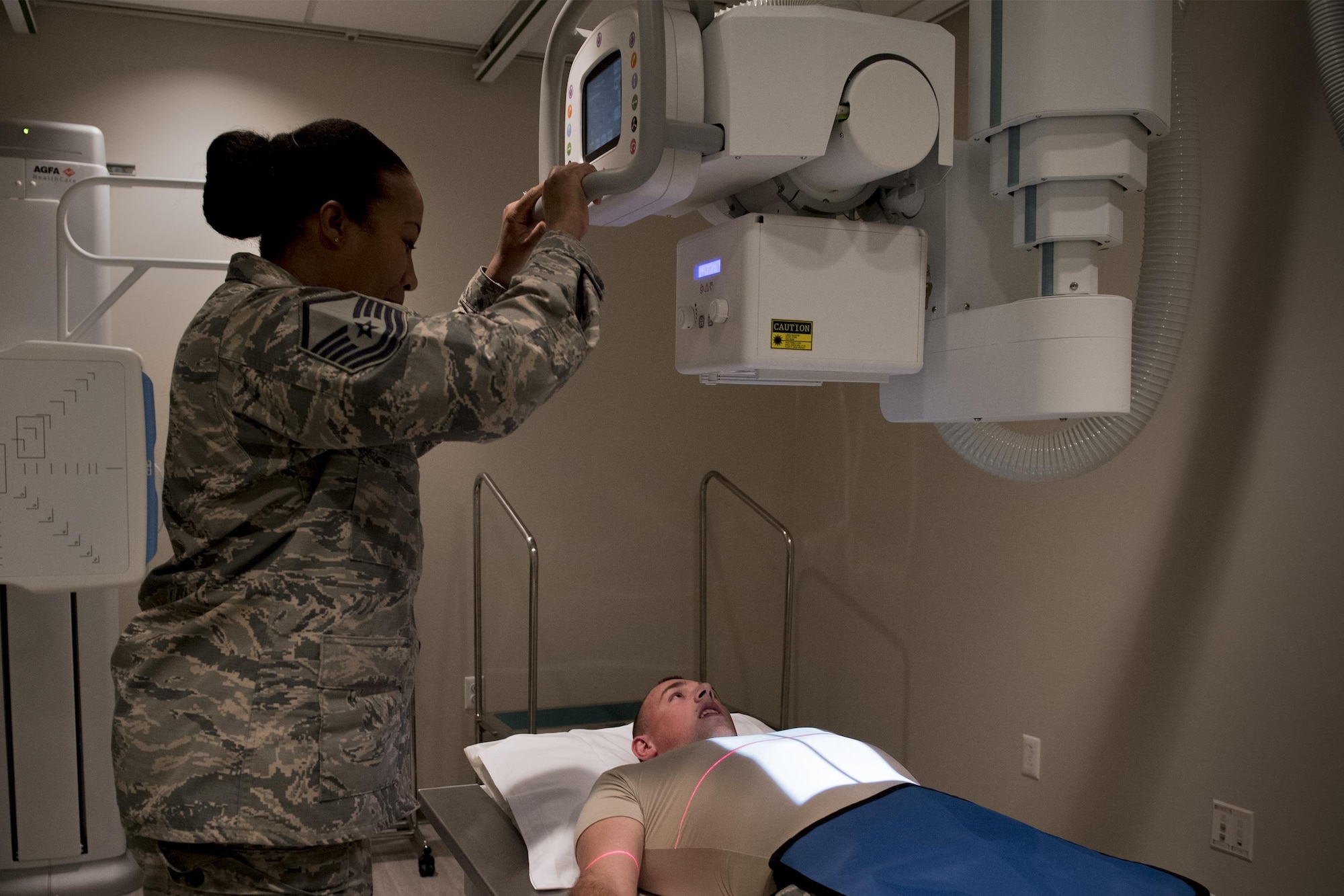 Master Sgt. Tracey McLendon, 23d Medical Support Squadron flight chief of diagnostic imaging, prepares a chest X-ray of Senior Airman Jeffrey Nelligan, 355th Medical Support Squadron diagnostic imagining technologist, Oct. 24, 2016, at Moody Air Force Base, Ga. The 23d MDSS radiology diagnostic imaging section consists of two Airmen who are responsible for the X-rays of approximately 10,000 people. (U.S. Air Force photo by Airman 1st Class Daniel Snider)

