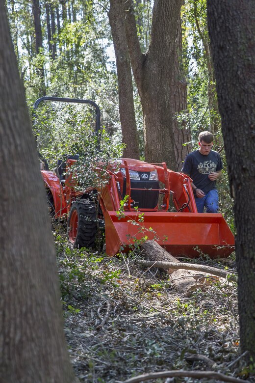 A Marine works to remove a fallen tree at another Marines’ house in the local community. The volunteer is part of a recovery platoon that assists Marines and families from the air station with hurricane recovery efforts. The Marine is with Marine Aviation Logistics Squadron 31 aboard Marine Corps Air Station Beaufort.