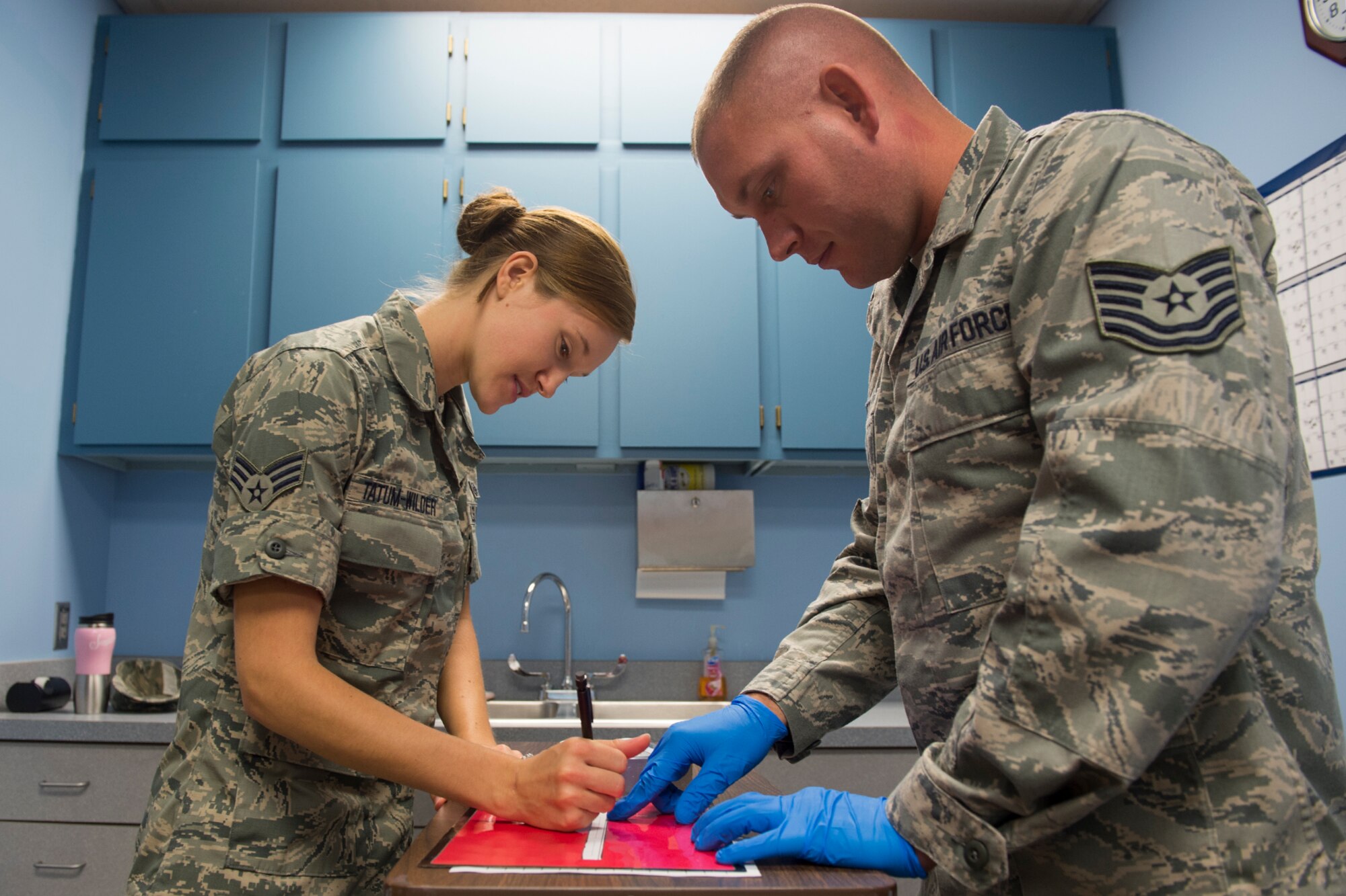 Senior Airman Melissa Tatum-Wilder, 434th Aerospace Medical Squadron dental assistant, and Tech. Sgt. John Dietz, 434th AMDS dental technician, sign the chain of custody form for a drug test sample October 2, 2016 at Grissom Air Reserve Base, Ind. Drug test samples must have a strict chain of custody to ensure security and prevent tampering. (U.S. Air Force photo/Staff Sgt. Jami Lancette)