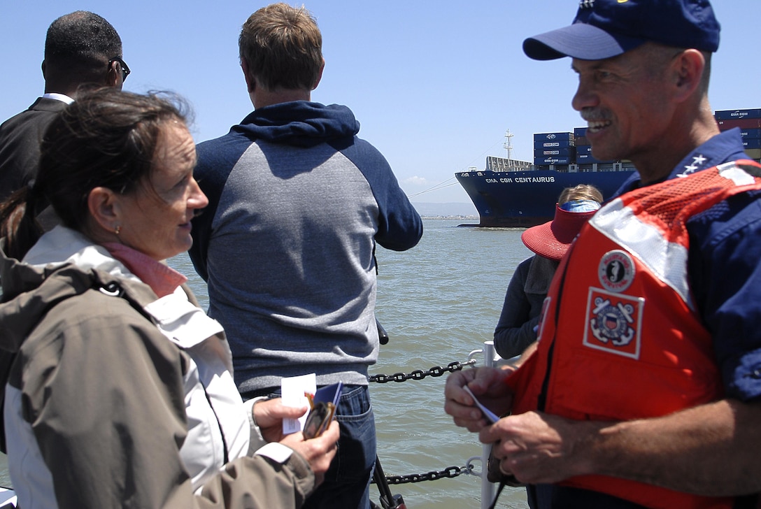 Pacific Area commander, speaks to a member of the San Francisco Harbor Safety Committee, aboard the Coast Guard Cutter Sockeye in the San Francisco Bay during a towing demonstration. The drill was intended as a learning experience to enhance preparedness for emergency towing operations. Coast Guard photo by Petty Officer 3rd Class Loumania Stewart (Coast Guard photo by Petty Officer 3rd Class Loumania Stewart)