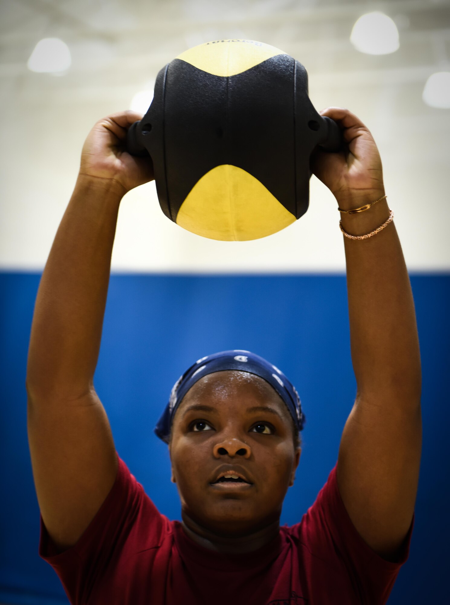 Senior Airman Tanaysha Redding, physical training rehab course participant, performs medicine ball squats during PTRC at Barksdale Air Force Base, La., October 25, 2016. Medicine ball squats focuses both upper and lower body muscle groups. (U.S. Air Force photo/Senior Airman Luke Hill)
