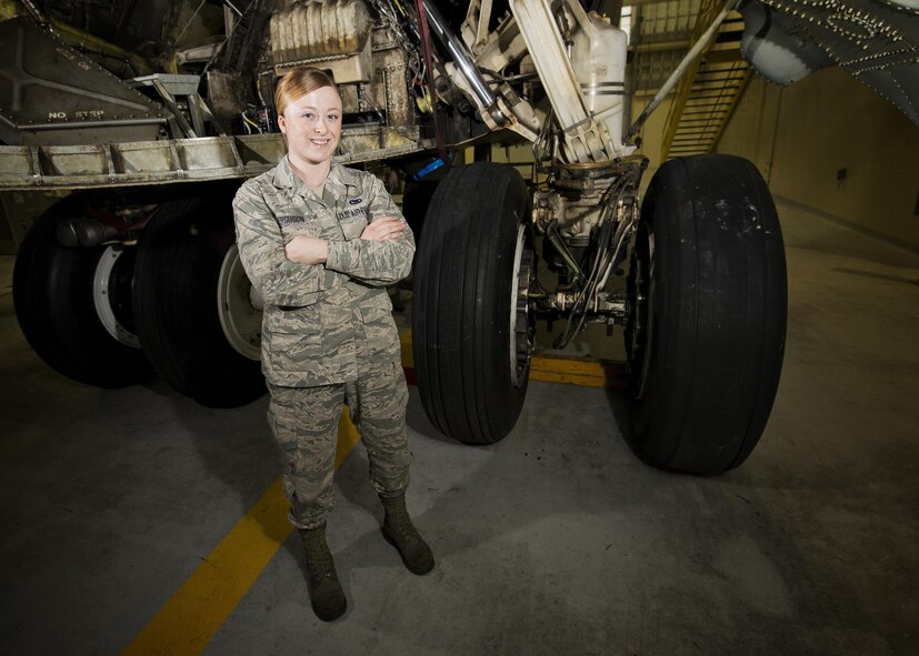 Airman 1st Class Madison Ferguson, 5th Maintenance Squadron phase crew chief, stands next to a B-52H Stratofortress’ landing gear at Minot Air Force Base, N.D., Oct. 21, 2016. Ferguson recently identified hazards on a critical landing gear component during a pre-flight inspection which prevented loss of life and capabilities. (U.S. Air Force photo/Airman 1st Class J.T. Armstrong)