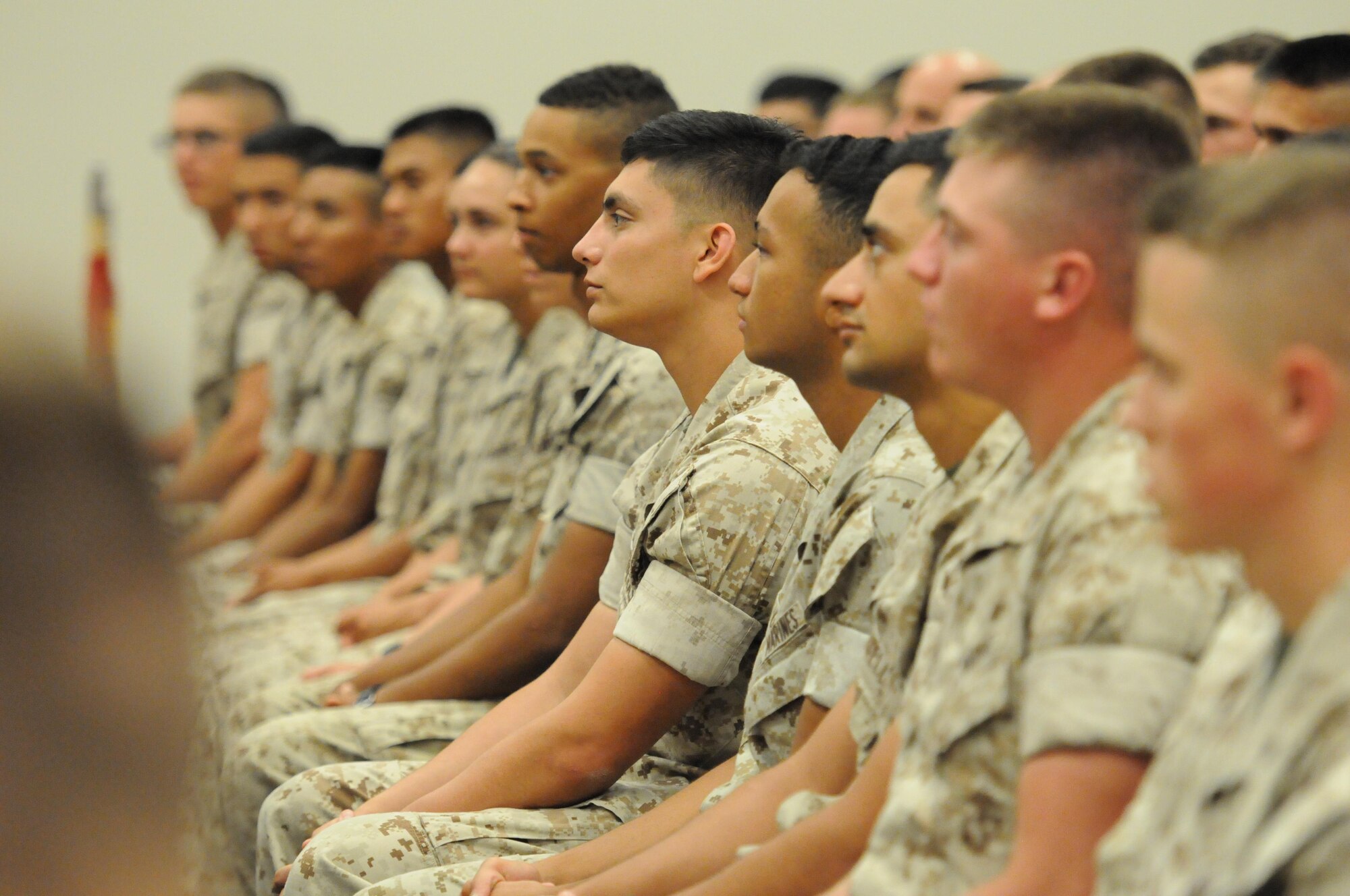 Keesler Marine Detachment members listen to Sergeant Major of the Marine Corps Ronald Green speak at the Roberts Consolidated Aircraft Maintenance Facility Oct. 26, 2016, on Keesler Air Force Base, Miss. Green spoke on the current and future stance of the Marine Corps and the impact the young Marines have on its future. (U.S. Air Force photo by Kemberly Groue/Released)