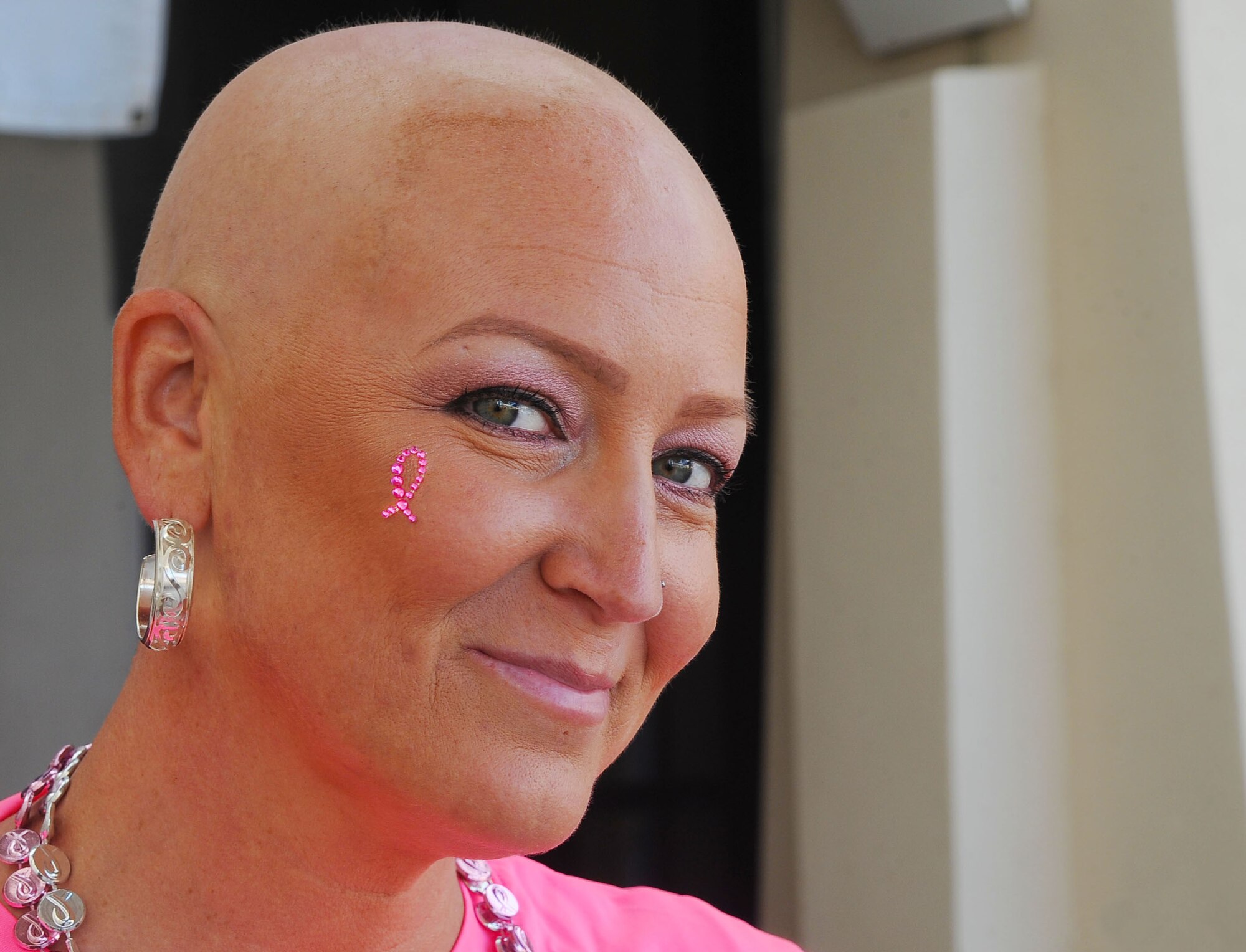 Tech. Sgt. Jenne Markovitz, NCO in charge of medical logistics with the 6th Medical Group, shows off her breast cancer awareness ribbon during the second annual Breast Cancer Awareness Walk at MacDill Air Force Base, Fla., Oct. 25, 2016. Markovitz was one of many breast cancer survivors who attended to help raise awareness. (U.S. Air Force photo by Airman Adam R. Shanks)