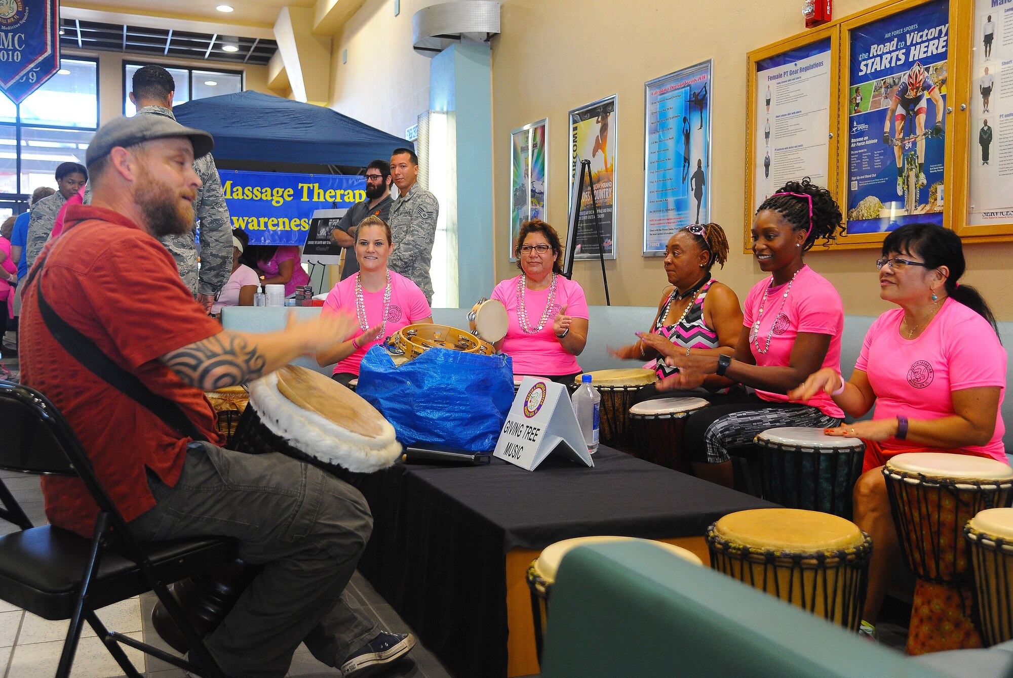 Members of Team MacDill play drums during the second annual Breast Cancer Awareness Walk at MacDill Air Force Base, Fla., Oct. 25, 2016. The event featured more than 20 interactive booths to help raise breast cancer awareness and show the many resources available to those who need support. (U.S. Air Force photo by Airman Adam R. Shanks)