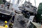 PORT VILA, Vanuatu--Contracted mariners aboard maritime preposition force ship USNS Pililaau (T-AKR 304) tend stabilization lines while using Pililaau's midships crane 4 to move maritime prepositioning force utility boat into the waters of Port Vila, Vanuatu, during KOA MOANA 16-4, Oct. 25.  The KOA MOANA (Ocean Warrior) exercise series seeks to enhance senior military leader engagements between allied and partner nations with a collective interest in military-to-military relations and to discuss key aspects of military operations, capability development, and interoperability.  