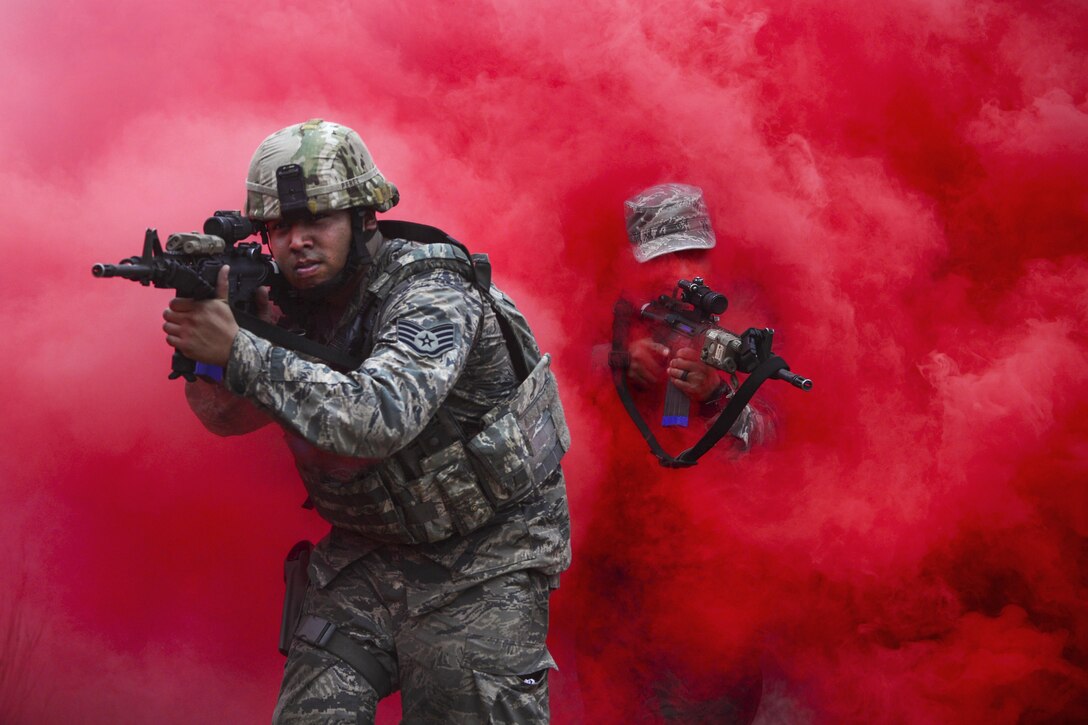 Airmen maneuver through concealing smoke during tactical combat casualty care training at Francis S. Gabreski Airport in Westhampton Beach, N.Y., Oct. 21, 2016. The airmen, assigned to the 106th Rescue Wing Security Forces Squadron, learned to react to enemy contact and attacks from improvised explosive devices while focusing on combat care. Air National Guard photo by Staff Sgt. Christopher S. Muncy



