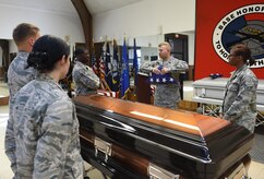 Senior Airman William Tramill, center, Air Force Honor Guard Mobile Team pallbearer trainer, displays how to properly dress the flag to base honor guard members here, Oct. 27, 2016. The mobile team goes from base to base to help train base honor guard members how to properly perform for an active duty funeral. 
