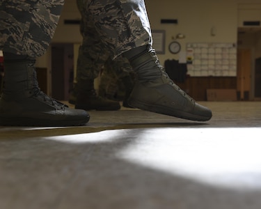 Base honor guard members learn how to glide their feet in unison here, Oct. 26, 2016. The current base honor guard training cycle is comprised of prior and new guard members being trained by an Air Force Honor Guard Mobile Team. 