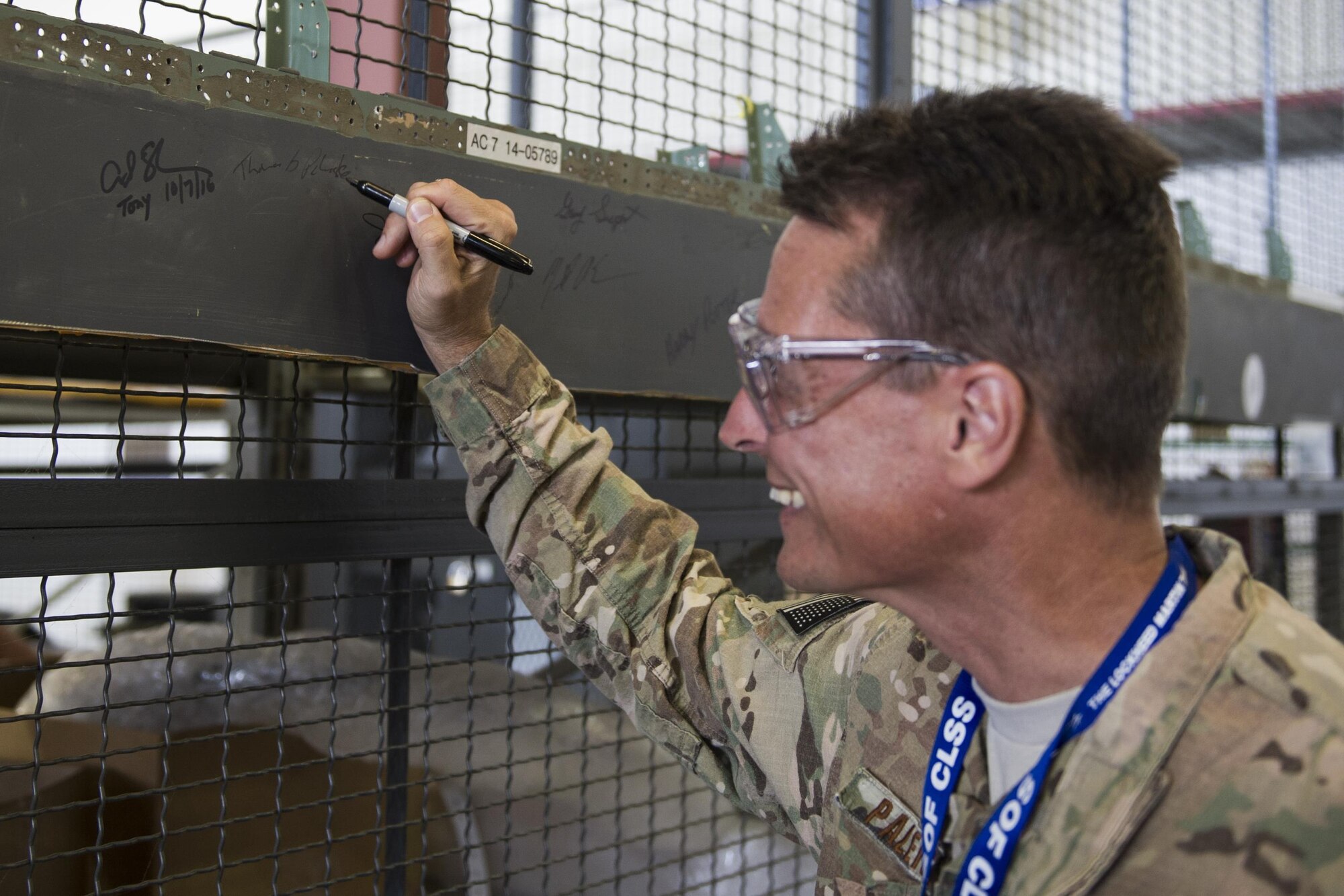 Col. Tom Palenske, commander of the 1st Special Operations Wing, signs an MC-130J Commando II aircraft part at Lockheed Martin in Crestview, Fla., Oct. 24, 2016. The Commando II fleet is being modified to become AC-130J Ghostrider gunships, providing the 1st SOW with improved close air support and air interdiction capabilities. (U.S. Air Force photo by Airman 1st Class Joseph Pick)