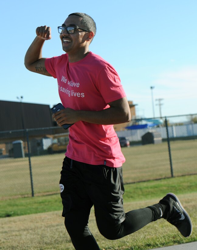 Airman 1st Class Roderick Williams, a bioenvironmental engineering technician assigned to the 28th Medical Operations Squadron, celebrates as the first person across the finish line during the Pink Day Parade and 5K at Ellsworth Air Force Base, S.D., Oct. 7, 2016. The run, along with spin and Zumba classes, were held in honor of Breast Cancer Awareness Month among other events throughout the week. (U.S. Air Force photo by Airman 1st Class Denise M. Jenson)
