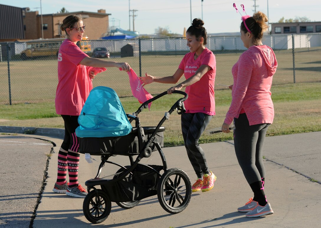 Second Lt. Miranda Simmons, a public affairs officer assigned to the 28th Bomb Wing, receives a sweat towel after being the first woman to complete the Pink Day Parade and 5K as part of Breast Cancer Awareness Month at Ellsworth Air Force Base, S.D., Oct. 7, 2016. Approximately 200 Airmen and civilians participated in the week’s events, which included five events throughout the week to help inform personnel and raise awareness for the disease. (U.S. Air Force photo by Airman 1st Class Denise M. Jenson)