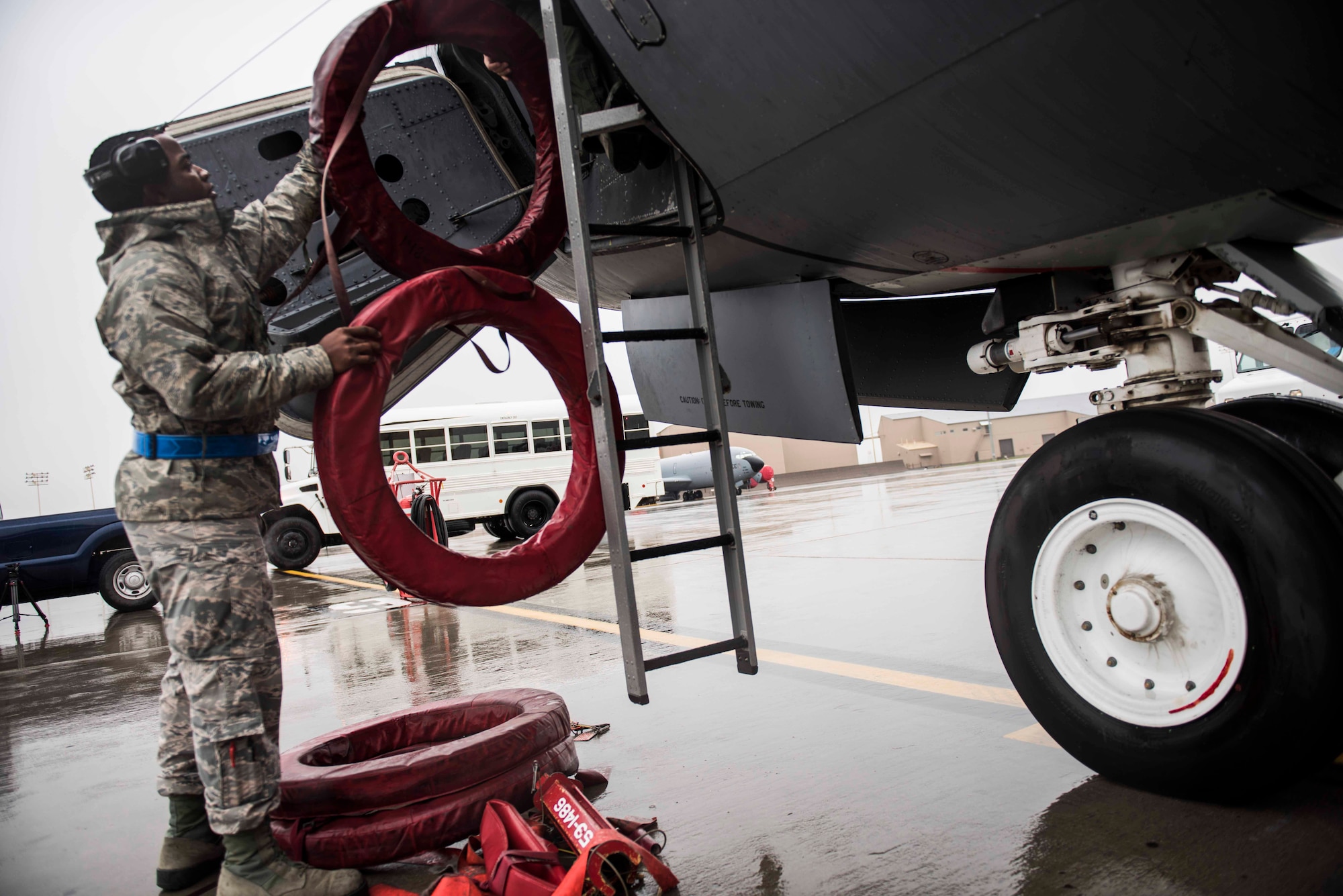Airman Alvin Carr, 92nd Maintenance Squadron crew chief, hands engine exhaust covers to Capt. Chad Halverstadt, 93rd Air Refueling Squadron pilot, Oct. 27, 2016 at Fairchild Air Force Base, Wash. Flight crew and crew chiefs prepared the KC-135R Stratotanker to execute wing's air refueling mission at a moment's notice. (U.S. Air Force photo/Senior Airman Nick J. Daniello)