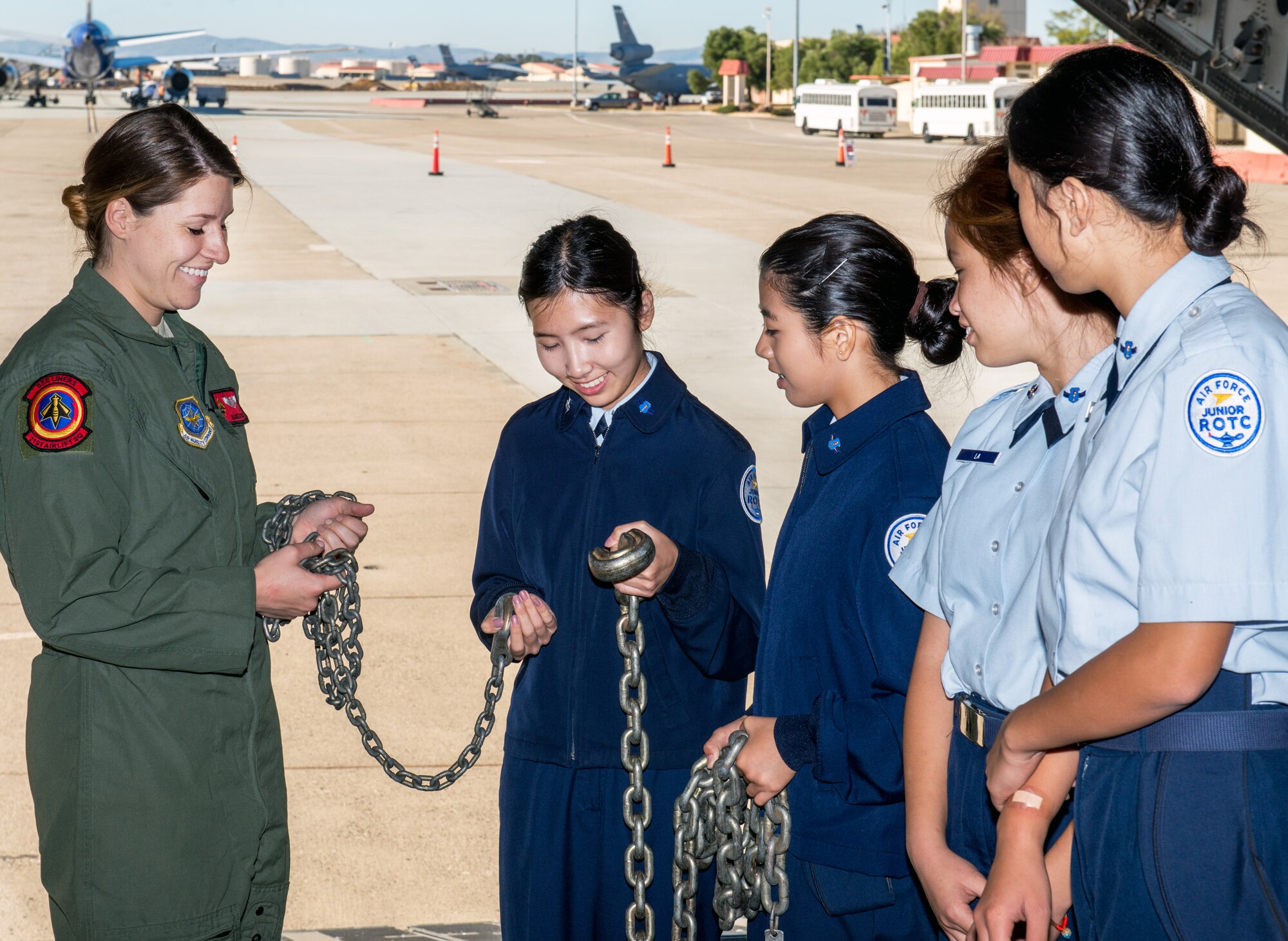 U.S. Air Force Senior Airman Jackie Justice, 21st Airlift Squadron, shows students from Oak Grove High School from San Jose, Calif., the tie downs used to secure cargo during their tour at Travis Air Force Base, Calif., Oct. 20, 2016. Travis hosted Junior Reserve Officer Training Corps students from five high schools in Northern Calif. Students toured several aircraft, air traffic control tower, dormitories, and had the opportunity to talk with personnel about military life. (U.S. Air Force photo by Louis Briscese)