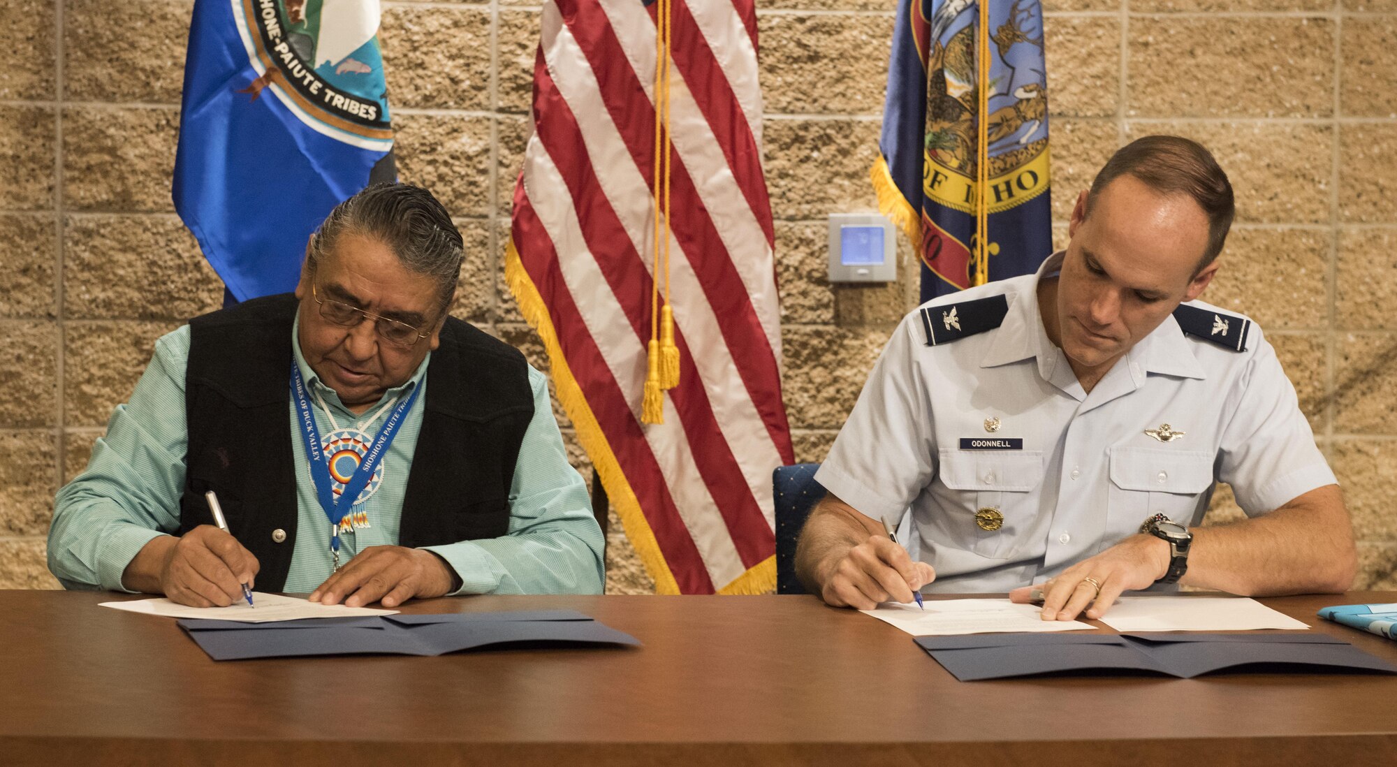 Col. Jefferson O'Donnell, 366th Fighter Wing commander, and Lindsey Manning, Chairman of the Shoshone-Paiute Tribes of the Duck Valley Indian Reservation, sign a five-year agreement at the Duck Valley Indian Reservation Oct. 20, 2016. The Duck Valley Indian Reservation, established in 1877, sits within the Mountain Home Air Force Base area of operation, creating a close relationship between base and tribal leadership. (U.S. Air Force photo by Senior Airman Connor J. Marth/Released)