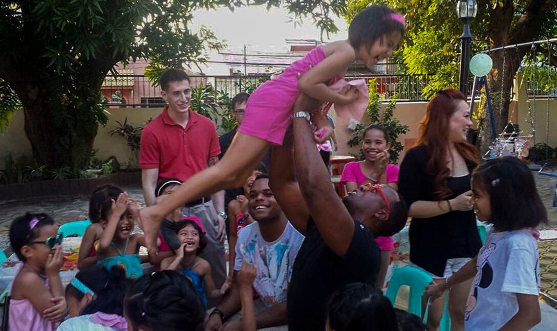U.S. Marine Corps Cpl. Dejon Pruitt, with 3rd Law Enforcement Battalion, III Marines Headquarters Group, III Marine Expeditionary Force, plays with the Filipino children at the White Cross Children’s Home during his volunteer trip to Manila, Philippines, Sept. 12 through Sept. 25, 2016. (U.S. Marine Corps photo)