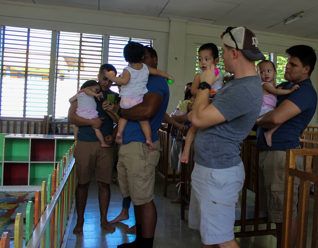U.S. Marines with 3rd Law Enforcement Battalion, III Marine Headquarters Group, III Marine Expeditionary Force play with the children of White Cross Children’s Home during their trip to Manila  from Sept. 12 through Sept. 25, 2016. The Marines installed a padded floor for the toddlers to play. The Marines had first visited the children’s home during their five month routine deployment. (U.S. Marine Corps photo)
