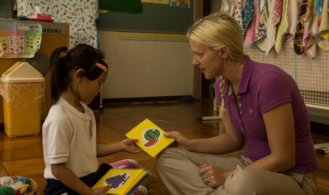 U.S. Marine Corps Maj. Eve Baker, a public affairs officer with III Marine Expeditionary Force, practices English with a student at Chatan-Daini Kindergarten during a visit to the school in Okinawa, Japan, Oct. 26, 2016. The Marines were able to show the local children the similarities between the U.S. and Japanese cultures through a variety of games and books. (U.S. Marine Corps photo by Lance Cpl. Kelsey Dornfeld)