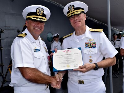 POLARIS POINT, Guam (Oct. 21, 2016) Rear Adm. Frederick J. Roegge, commander of Submarine Force, U.S. Pacific Fleet, right, awards the Legion of Merit to Capt. Mark A. Prokopius, left, the commanding officer of the submarine tender USS Emory S. Land (AS 39). Prokopius received the award during the change-of-command ceremony aboard Emory S. Land. (U.S. Navy photo by Seaman Daniel S. Willoughby/RELEASED) 