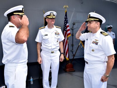 POLARIS POINT, Guam (Oct. 21, 2016) Capt. Douglas A. Bradley, right, relieves Capt. Mark A. Prokopius, left, as commanding officer of the submarine tender USS Emory S. Land (AS 39) as Rear Adm. Frederick J. Roegge, commander of Submarine Force, U.S. Pacific Fleet, presides. The change-of-command ceremony was held aboard Emory S. Land. (U.S. Navy photo by Seaman Daniel S. Willoughby/RELEASED) 