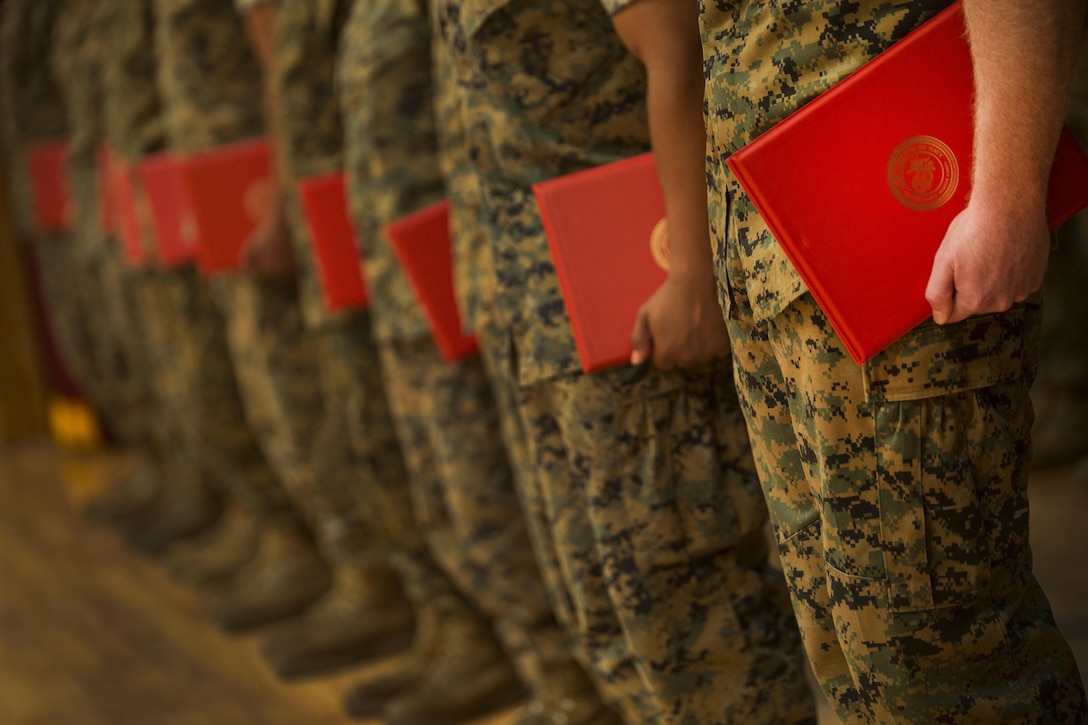 Twenty one Marines reenlisted all at once Oct. 27, 2016 at Camp Foster Okinawa, Japan. Monitors and career planners from Manpower Management Division Enlisted Assignments, Headquarters United States Marine Corps, visited Okinawa to help Marines progress in their Marine Corps path. The monitors are able to sit down individually with the Marines to enhance the permanent change of station process. (U.S. Marine Corps photo by Sgt. Isaac Ibarra/Released)