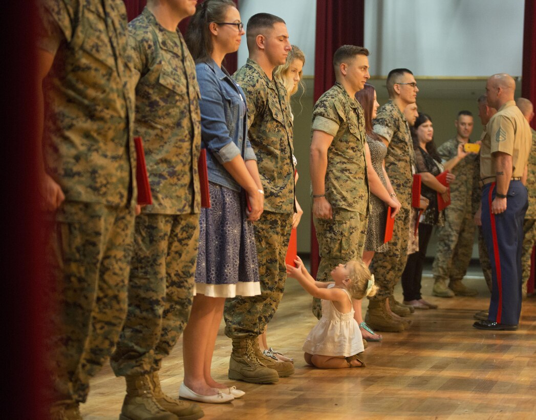 Twenty one Marines reenlisted on the spot Oct. 27, 2016 at Camp Foster Okinawa, Japan. Many families came in support of the Marines, and before the ceremony Lt. Gen. Lawrence D. Nicholson expressed the importance of family among the service members. Monitors and career planners from Manpower Management Division Enlisted Assignments, Headquarters United States Marine Corps, visited Okinawa to help Marines progress in their Marine Corps path. The monitors are able to sit down individually with the Marines to enhance the permanent change in station process. (U.S. Marine Corps photo by Sgt. Isaac Ibarra/Released)
