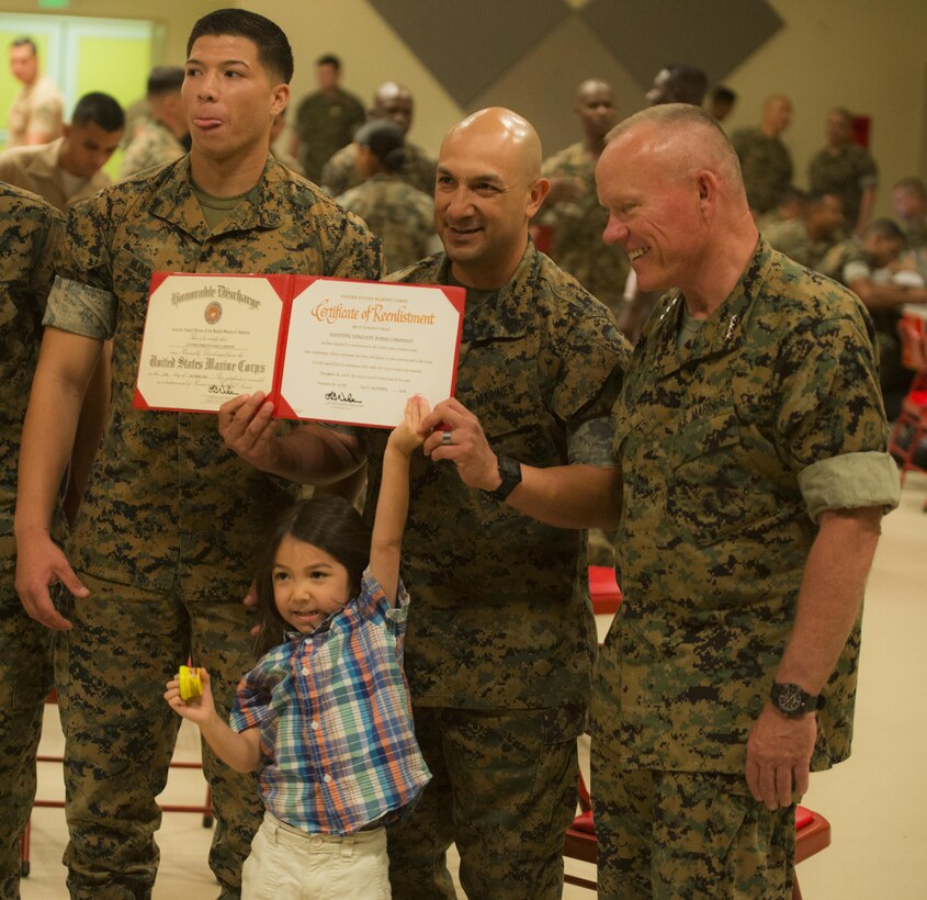Twenty one Marines reenlisted on the spot Oct. 27, 2016 at Camp Foster Okinawa, Japan. Many families came in support of the Marines, and before the ceremony Lt. Gen. Lawrence D. Nicholson expressed the importance of family among the service members. Monitors and career planners from Manpower Management Division Enlisted Assignments, Headquarters United States Marine Corps, visited Okinawa to help Marines progress in their Marine Corps path. The monitors are able to sit down individually with the Marines to enhance the permanent change in station process. (U.S. Marine Corps photo by Sgt. Isaac Ibarra/Released)