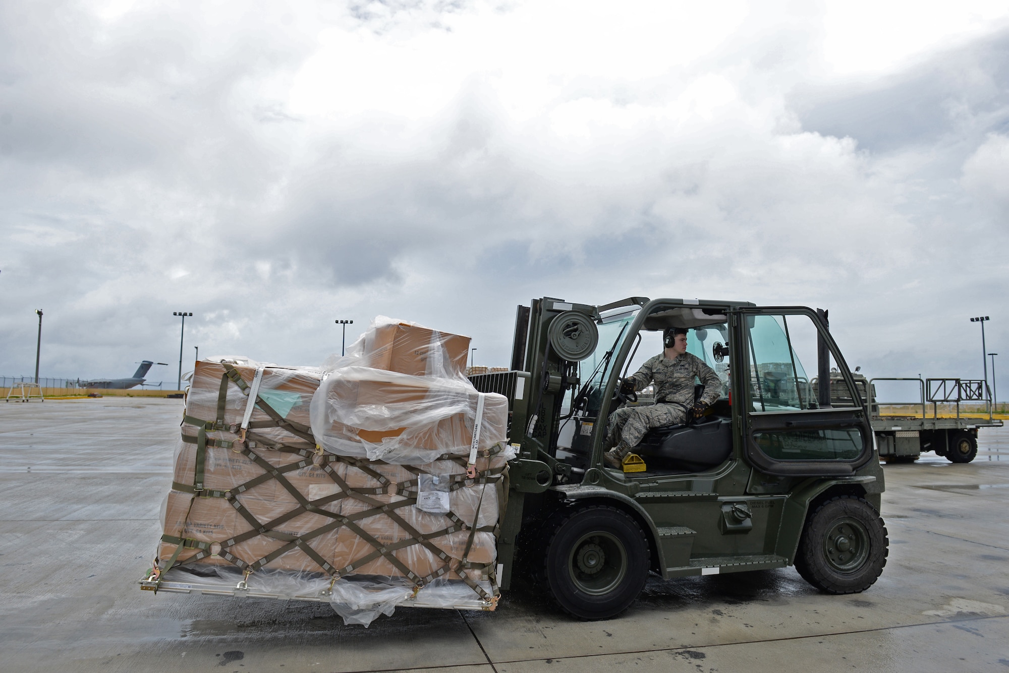 Staff Sgt. Randy Adkison, 734th Air Mobility Squadron freight supervisor, uses a forklift to transport a pallet of coffee August 18, 2016, at Andersen Air Force Base, Guam. The 36th Wing Chapel uses coffee as a tool to bridge the gap between service members and the Chaplain Corps. (U.S. Air Force photo by Airman 1st Class Jacob Skovo)