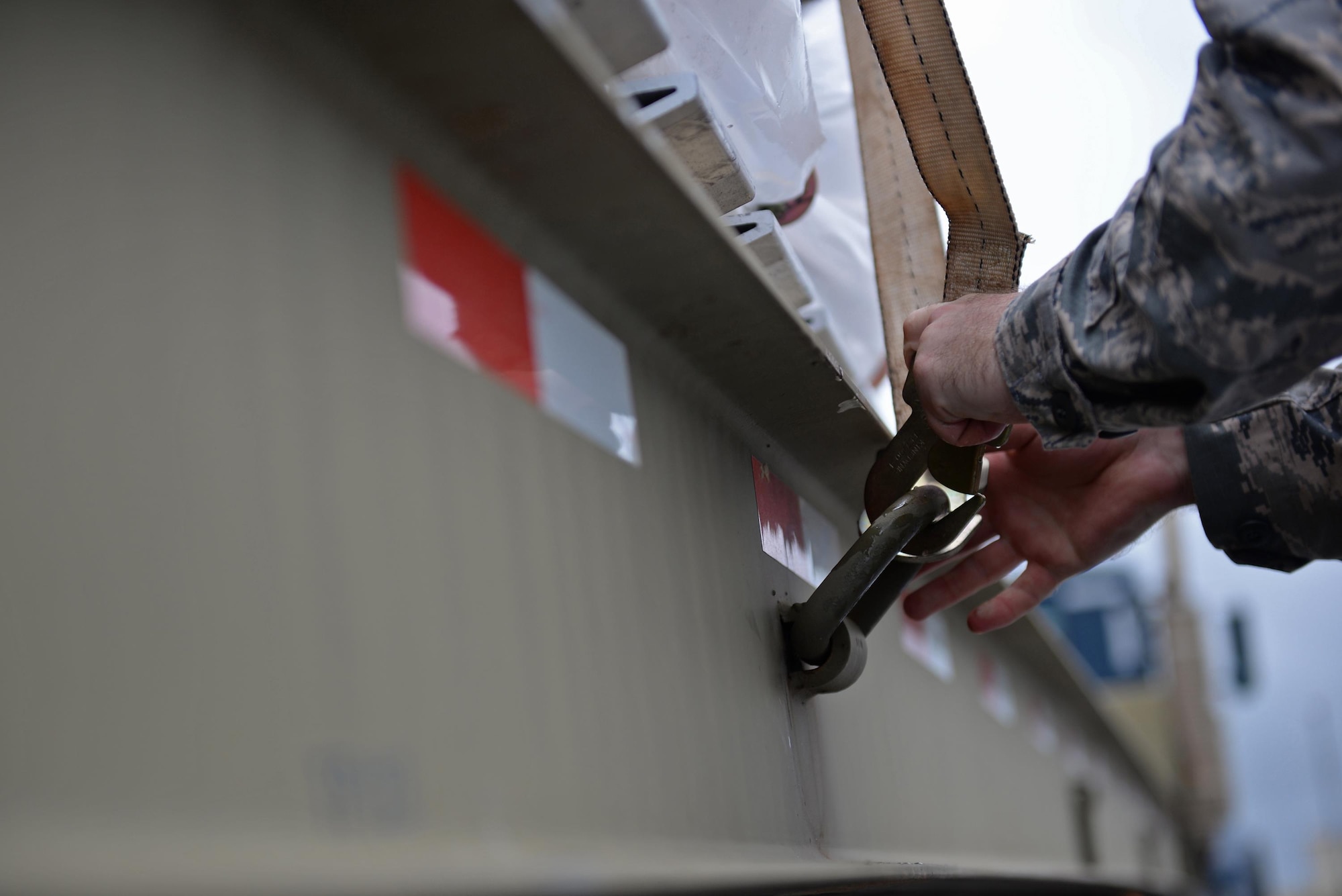 Staff Sgt. Andrew Welch, 554th RED HORSE Squadron construction equipment operator, secures a pallet of coffee to a flatbed truck August 18, 2016, at Andersen Air Force Base, Guam. The 554th RHS supports the 36th Wing Chapel by transporting and storing coffee after it arrives on base. (U.S. Air Force photo by Airman 1st Class Jacob Skovo)