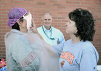 Robert Helgeson, 76th Propulsion Maintenance Group director, watches from a safe distance as Carolyn Davis, F-100 PLS supervisor smacks Jetta Reed, both of the 547th Propulsion Maintenance Squadron, with a plate of gooey whipped cream at the 76th PMXG’s annual fundraiser for the Combined Federal Campaign Oct. 21. This year’s event was a “Pie in the Face” fundraiser where members of each of the group’s squadrons could donate money to see their favorite supervisor get a face-full of whipped cream. At this event alone, PMXG raised $1,734. (Air Force photo by Kelly White)