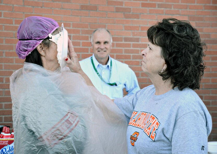 Robert Helgeson, 76th Propulsion Maintenance Group director, watches from a safe distance as Carolyn Davis, F-100 PLS supervisor smacks Jetta Reed, both of the 547th Propulsion Maintenance Squadron, with a plate of gooey whipped cream at the 76th PMXG’s annual fundraiser for the Combined Federal Campaign Oct. 21. This year’s event was a “Pie in the Face” fundraiser where members of each of the group’s squadrons could donate money to see their favorite supervisor get a face-full of whipped cream. At this event alone, PMXG raised $1,734. (Air Force photo by Kelly White)