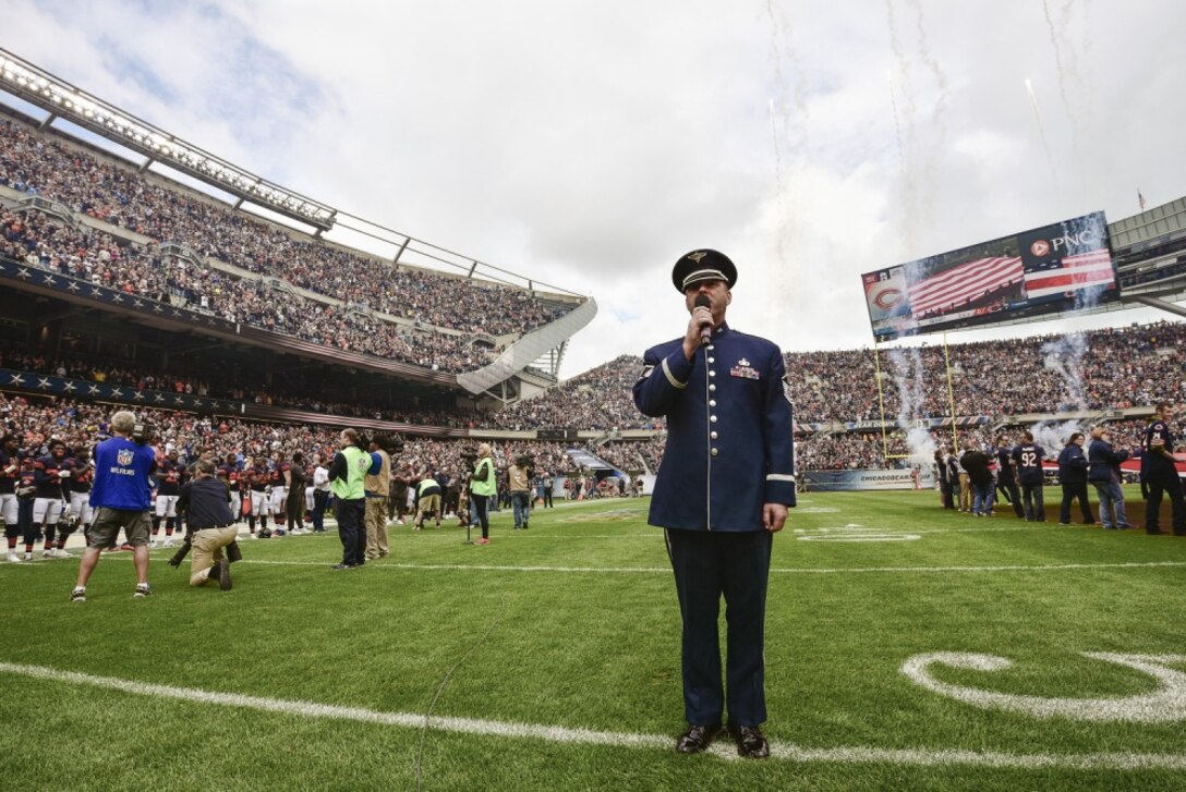 U.S. Air Force Master Sgt. Eric Sullivan, a baritone vocalist with the United States Air Force Band’s “Singing Sergeants”, sings “The Star-Spangled Banner” before an NFL football game at Soldier Field in Chicago, Ill., Oct. 2, 2016. Sullivan performed the national anthem for an audience of more than 60,800 people as part of the unit’s community relations mission. (U.S. Air National Guard photo by Tech. Sgt. Lealan Buehrer)