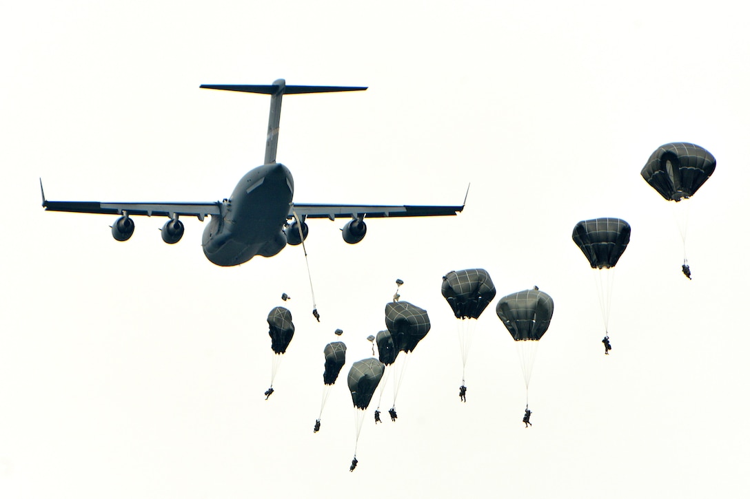 U.S. and NATO paratroopers jump out of a C-17 Globemaster aircraft as part of the Peacemaster Unity airborne exercise in Pordenone, Italy, Oct. 17, 2016. Army photo by Paolo Bovo