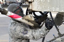 Tech. Sgt. Michael Massey, 386th Expeditionary Civil Engineering Squadron pavements and equipment craftsman, pours concrete at an undisclosed location in Southwest Asia 24 Oct., 2016. The 386th ECES is expanding sunshades to prepare for an upcoming transition from MQ-1 Predators to MQ-9 Reapers. (U.S. Air Force photo by Capt. Casey Osborne/Released)