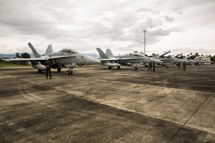 U.S. Marine Corps F/A-18D Hornets with Marine All-Weather Fighter Attack Squadron (VMFA (AW)) 225, arrive at Sam Ratulangi International Airport, Indonesia, in preparation of exercise Cope West 17, Oct. 27, 2016. This fighter-focused, bilateral exercise between the U.S. Marine Corps and Indonesian Air Force is designed to enhance the readiness of combined interoperability between the two nations. The squadron plans to complete their unit air-to-air training requirements, which focuses on basic fighter maneuvering, section engaged maneuvering, offensive anti-air warfare and active air defense versus the Indonesian Air Force to increase situational readiness, interoperability, knowledge and partnership between the U.S. and Indonesia. (U.S. Marine Corps photo by Lance Cpl. Aaron Henson)