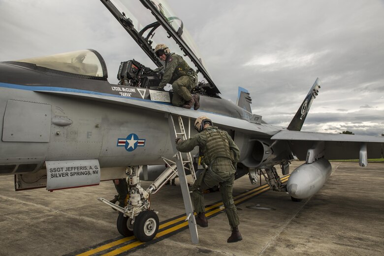 U.S. Marine Corps Lt. Col. Stephen N. McClune, bottom, commanding officer, and Maj. Jon Von Seggern, operations officer of Marine All-Weather Fighter Attack Squadron (VMFA (AW)) 225, exit their F/A-18D Hornet upon arrival to Sam Ratulangi International Airport, Indonesia, in preparation of exercise Cope West 17, Oct. 27, 2016. This fighter-focused, bilateral exercise between the U.S. Marine Corps and Indonesian Air Force is designed to enhance the readiness of combined interoperability between the two nations. Cope West 17 is the first fighter-focused exercise in 19 years involving the U.S. Marine Corps and Indonesian Air Force. (U.S. Marine Corps photo by Lance Cpl. Aaron Henson)
