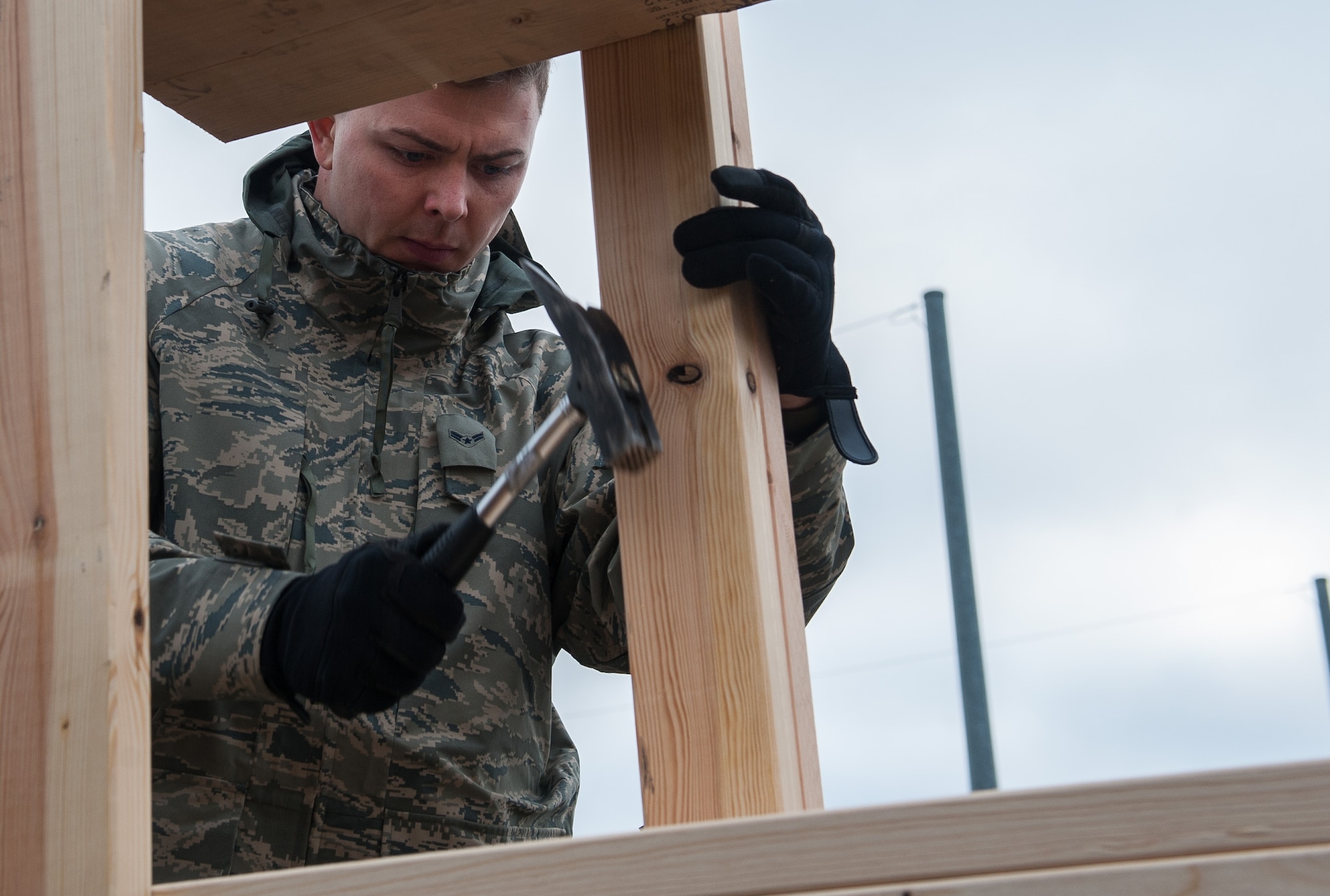 Airman 1st Class David Osborne, 86th Logistic Readiness Squadron traffic management journeyman, constructs palettes together during an 86th Munitions Squadron exercise at Ramstein Air Base, Germany, Oct. 25, 2016. Wooden frames are built after the pallets are cut the right length, and then are braced against the shipping containers for maximum protection against damage to the equipment it’s braced with. (U.S. Air Force photo by Airman 1st Class Lane T. Plummer)