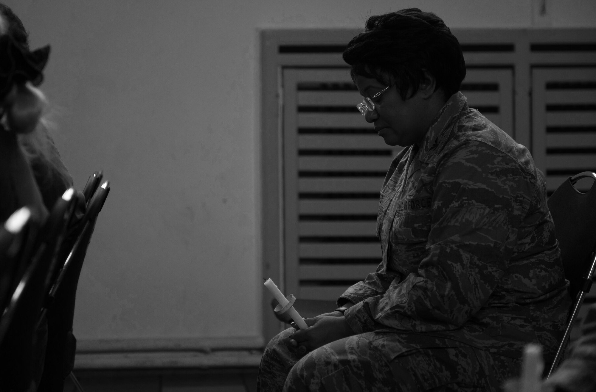 Col. Donnette Boyd, 86th Airlift Wing chaplain, holds a moment of silence to remember the victims of interpersonal violence during a candlelight vigil at Ramstein Air Base, Germany, Oct. 27, 2016. According to the Center for Disease Control and Prevention, over the course of a year, more than 10 million U.S. citizens are victims of domestic violence, sexual abuse, child violence and bullying or suicide. The devastating physical, emotional, and psychological consequences of interpersonal violence can cross generations and last lifetimes. (U.S. Air Force photo by Airman 1st Class Lane T. Plummer)