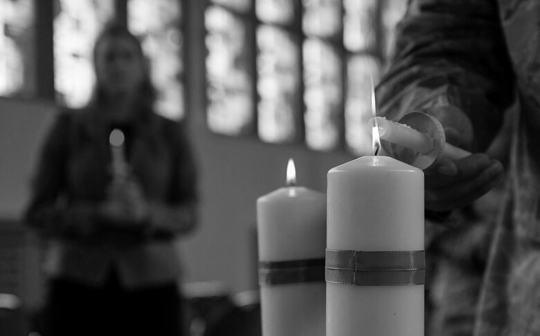 An Airman lights her candle in honor of a victim of interpersonal violence during a candlelight vigil at Ramstein Air Base, Germany, Oct. 27, 2016. According to the Center for Disease Control and Prevention, over the course of a year, more than 10 million U.S. citizens are victims of domestic violence, sexual abuse, child violence and bullying or suicide. The devastating physical, emotional, and psychological consequences of interpersonal violence can cross generations and last lifetimes. (U.S. Air Force photo by Airman 1st Class Lane T. Plummer)