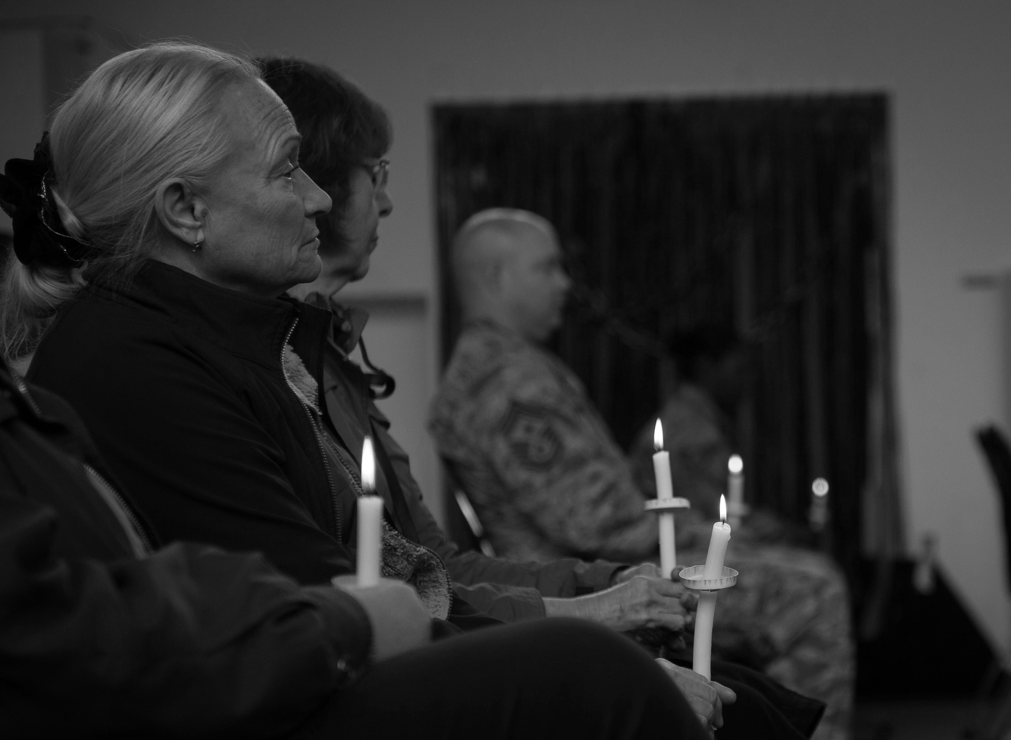 A woman sits and listens to guest speakers at a candlelight vigil at Ramstein Air Base, Germany, Oct. 27, 2016. According to the Center for Disease Control and Prevention, over the course of a year, more than 10 million U.S. citizens are victims of domestic violence, sexual abuse, child violence and bullying or suicide. The devastating physical, emotional, and psychological consequences of interpersonal violence can cross generations and last lifetimes. (U.S. Air Force photo by Airman 1st Class Lane T. Plummer)