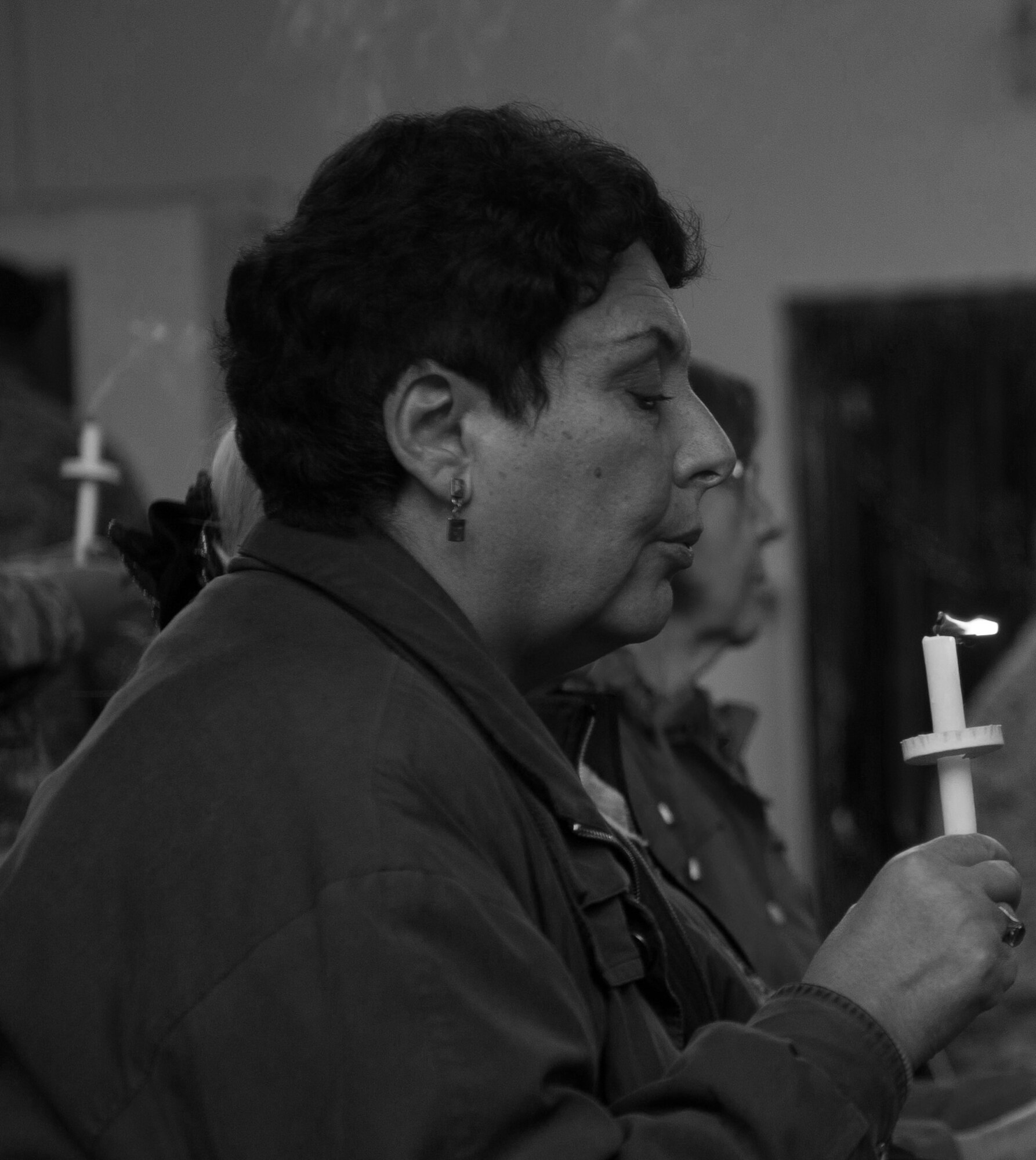 A woman blows out her candle to signal the end of a candlelight vigil at Ramstein Air Base, Germany, Oct. 27, 2016. According to the Center for Disease Control and Prevention, over the course of a year, more than 10 million U.S. citizens are victims of domestic violence, sexual abuse, child violence and bullying or suicide. The devastating physical, emotional, and psychological consequences of interpersonal violence cross generations and last lifetimes. (U.S. Air Force photo by Airman 1st Class Lane T. Plummer)