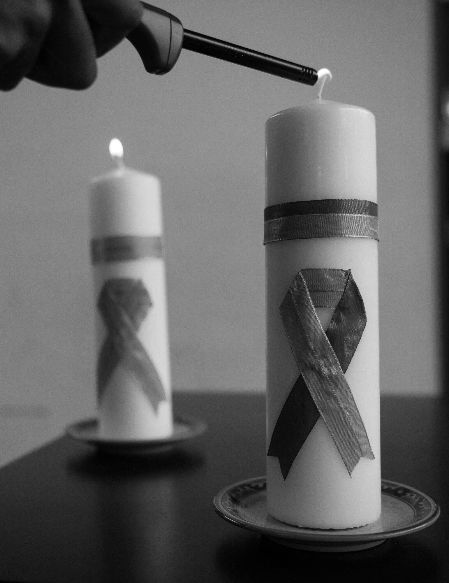 Candles are lit to remember the victims of interpersonal violence at a candlelight vigil at Ramstein Air Base, Germany, Oct. 27, 2016. Each candle is marked with different-colored ribbons, representing the four categories that interpersonal violence covers: domestic violence, sexual abuse, child abuse, and bullying. According to the Center for Disease Control and Prevention, over the course of a year more than 10 million U.S. citizens are victims of interpersonal violence. The devastating physical, emotional, and psychological consequences of these events can cross generations and last lifetimes. (U.S. Air Force photo by Airman 1st Class Lane T. Plummer)