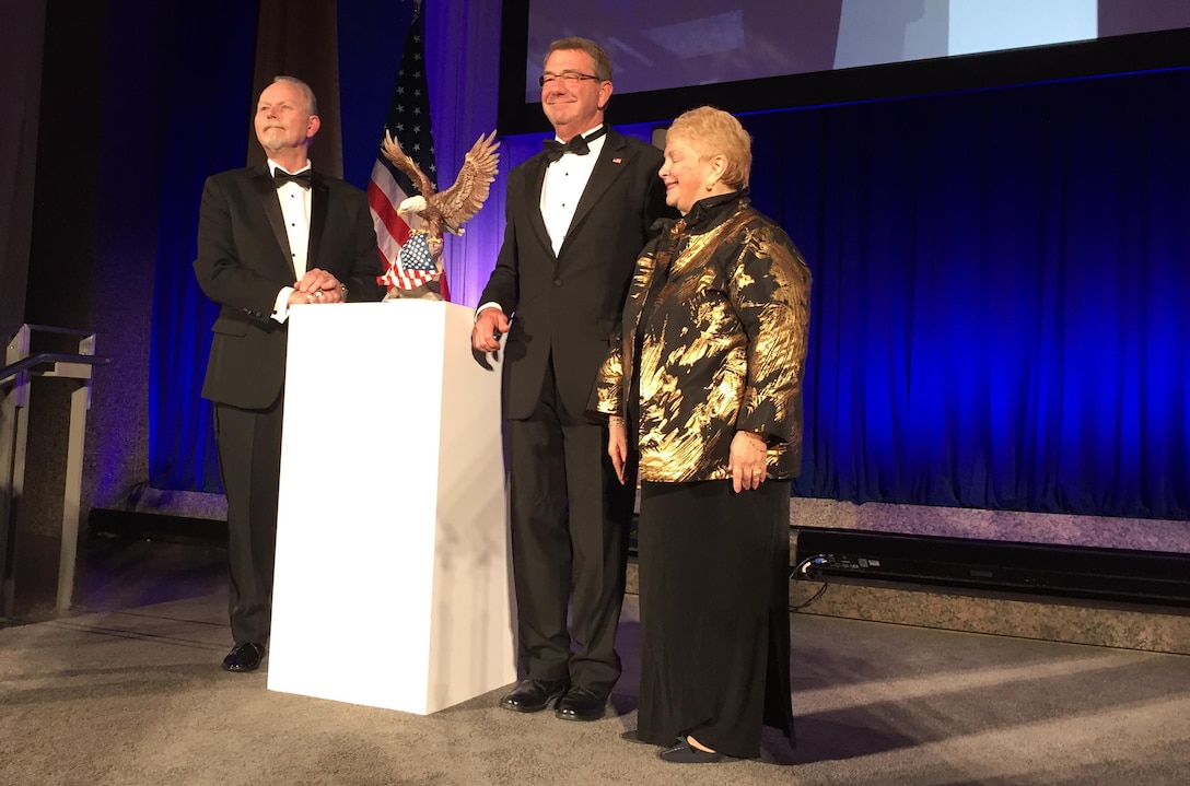 Defense Secretary Ash Carter, center, accepts the Patriot Award from National Defense University Foundation President Lawrence Rzepka and Sheila R. Ronis during a ceremony at the Reagan Building in Washington Oct. 27, 2016. DoD photo by Jim Garamone