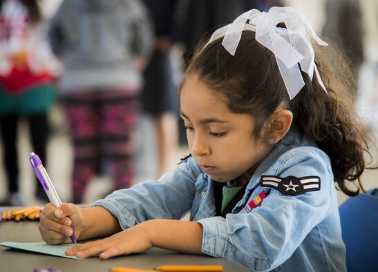 A new airman first class writes a letter to her friends and family while “deployed” during the Operation Hero event Oct. 22, 2016, at Eglin Air Force Base, Fla.  More than 100 kids participated in the mock deployment experience created to give military children a glimpse of what their loved ones go through when they leave home. The kids went through a deployment line to receive dog tags and “immunizations” before they were briefed by the commander and shipped off to a deployed location. There, they participated in various activities and demonstrations by local base agencies. (U.S. Air Force photo/Samuel King Jr.)