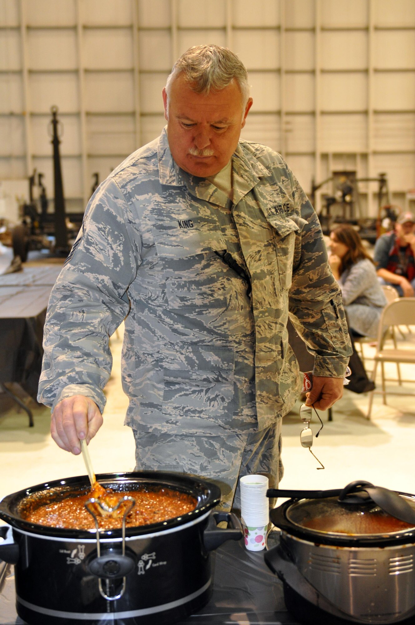 Master Sgt. Gregory King, 445th Maintenance Squadron HSC section chief, gives his pot of chili one final stir before the judging began for the 445th Airlift Wing’s 16th Annual Chili Cook-off Oct. 27, 2016. King won first place in the chili cook-off for his chili titiled, “Southeastern Ohio Inspired Chili.” The event raised $400 for the Combined Federal Campaign. (U.S. Air Force photo/Stacy Vaughn)